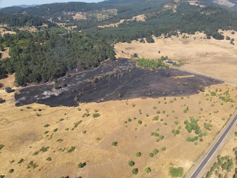 Firefighters watch as a helicopter drops water on the Gap Road Fire. --Photos courtesy of Brownsville Fire Department