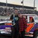Street Stocks Trophy Dash winner Danner Myers (left) celebrates with honorary trophy girl Denise Estep (right), who returned to present trophies after once serving as a Willamette Speedway trophy girl years ago.
